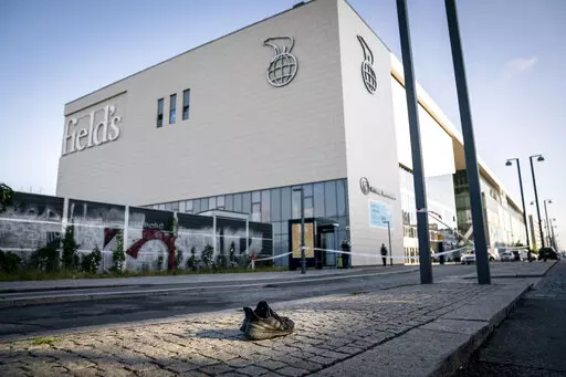 A shoe was abandoned in front of the shopping centre Fields, closed for at least a week after Sunday shooting, as police is investigating the crime scene the day after, in Copenhagen, Denmark, Monday, July 4, 2022. Danish police believe a shopping mall shooting that left three people dead and four others seriously wounded was not terror-related. They said Monday that the gunman acted alone and appears to have selected his victims at random. (Mads Claus Rasmussen/Ritzau Scanpix via AP)