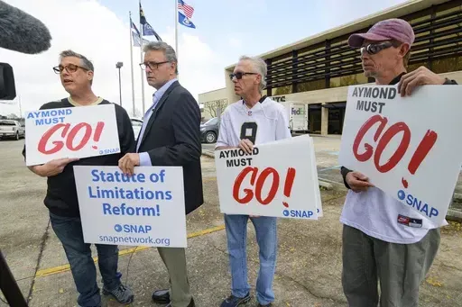Members of SNAP, the Survivors Network of those Abused by Priests, including, from left, Kevin Bourgeois, John Gianoli, Richard Windmann and John Anderson, hold signs during a conference in front of the New Orleans Saints training facility, Jan. 29, 2020, in Metairie, La. Officially reversing a controversial March ruling, Louisiana’s highest court on Wednesday, June 12, 2024, gave childhood victims of sexual abuse a renewed opportunity to file damage lawsuits. (AP Photo/Matthew Hinton, File)