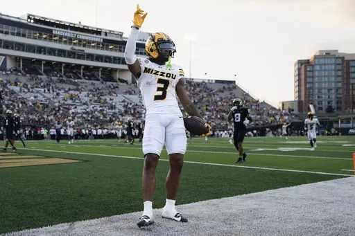 Missouri wide receiver Luther Burden III (3) celebrates a touchdown against Vanderbilt in the second half of an NCAA college football game Saturday, Sept. 30, 2023, in Nashville, Tenn. (AP Photo/George Walker IV)