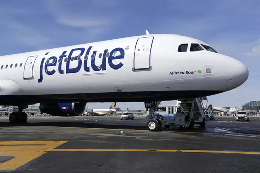 A JetBlue airplane is seen, March 16, 2017, at John F. Kennedy International Airport in New York. JetBlue Airways will end service at several cities and reduce flying out of Los Angeles in a move to retrench and focus on stronger markets after years of losing money. (AP Photo/Seth Wenig, File)