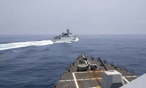 In this photo provided by the U.S. Navy, the USS Chung-Hoon observes a Chinese navy ship conduct what it called an "unsafe” Chinese maneuver in the Taiwan Strait, Saturday, June 3, 2023, in which the Chinese navy ship cut sharply across the path of the American destroyer, forcing the U.S. ship to slow to avoid a collision. The incident occurred as the American destroyer and Canadian frigate HMCS Montreal were conducting a so-called “freedom of navigation” transit of the strait between Taiw