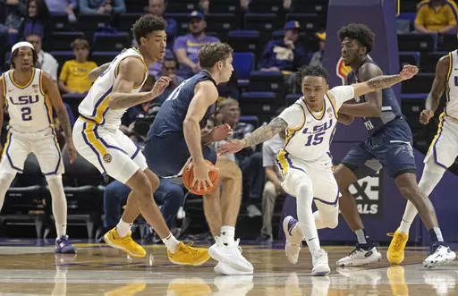 LSU forward Jalen Reed (13) and forward Tyrell Ward (15) defend against North Florida guard Nate Lliteras (11) during an NCAA college basketball game Friday, Nov. 24, 2023, in Baton Rouge, La. (Hilary Scheinuk/The Advocate via AP)