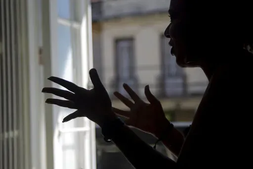 Diana gives an interview in Havana, Cuba, Thursday, Nov. 3, 2022. Diana said she endured screams, insults and confinement for seven years before she ended a seven year relationship with her boyfriend, but that she did not reach out to any institutions or programs that handled cases of violence against women because she had no faith that they could protect her. Diana asked that her last name not be published because she was afraid for her safety.  (AP Photo/Ismael Francisco)
