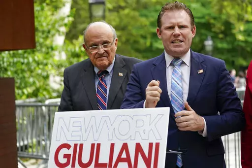 Andrew Giuliani, right, a Republican candidate for Governor of New York, is joined by his father, former New York City mayor Rudy Giuliani, during a news conference, June 7, 2022, in New York. One place the former New York City mayor is in high demand these days is on the campaign of his son, Andrew Giuliani, who on Tuesday is hoping to become the Republican nominee for governor of New York. (AP Photo/Mary Altaffer, File)