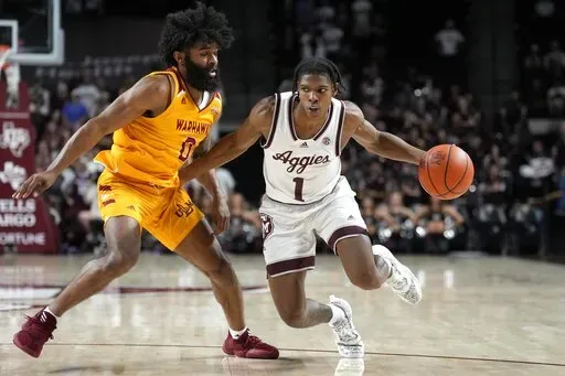 Texas A&M guard Khalen Robinson (1) drives the lane against Louisiana-Monroe guard Jamari Blackmon (0) during the second half of an NCAA college basketball game Monday, Nov. 7, 2022, in College Station, Texas. (AP Photo/Sam Craft)