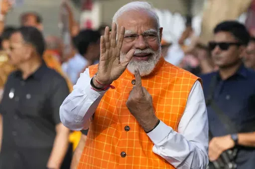 Indian Prime Minister Narendra Modi, shows the indelible ink mark on his index finger after casting his vote during the third phase of general elections, in Ahmedabad, Gujarat, India, Tuesday, May 7, 2024. (AP Photo/Ajit Solanki)