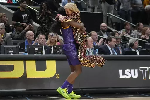 LSU head coach Kim Mulkey celebrates with Flau'jae Johnson during the second half of the NCAA Women's Final Four championship basketball game against Iowa Sunday, April 2, 2023, in Dallas. LSU won 102-85 to win the championship. (AP Photo/Darron Cummings)