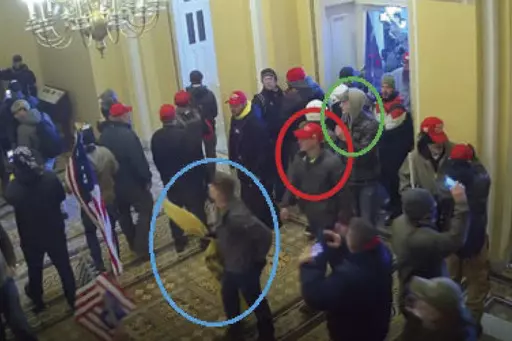 In this image from U.S. Capitol Police video, released and annotated by the Justice Department in the Statement of Facts supporting an arrest warrant, Joshua Abate, circled in green, Micah Coomer, circled in red, and Dodge Dale Hellonen, circled in blue, appear inside the U.S. Capitol on Jan. 6, 2021, in Washington. Abate and Hellonen, who were active-duty members of the Marines Corps when they stormed the U.S. Capitol, pleaded guilty on Monday, June 12, 2023, to riot-related criminal charges. C