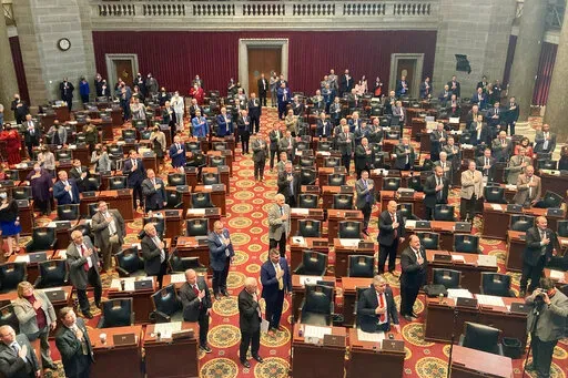 Members of the Missouri House of Representatives recite the Pledge of Allegiance as they begin their annual legislative session, Jan. 5, 2022, in Jefferson City, Mo. Women who serve in the Missouri House will face a tougher dress code when they return to the floor this week after a debate that Democrats panned as a pointless distraction from the issues facing the state. The new rules require female legislators and staff members to wear a jacket such as a cardigan or blazer. The Republican lawmak