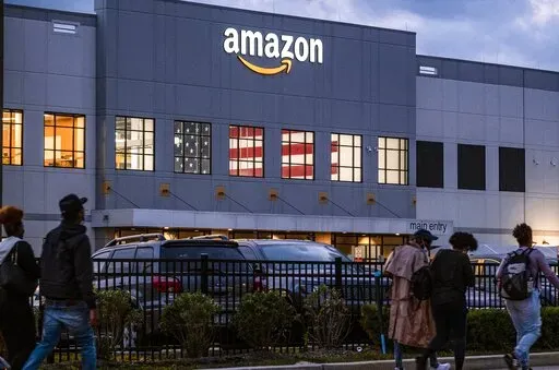 People arrive for work at the Amazon distribution center in the Staten Island borough of New York, on Oct. 25, 2021. Amazon plans to file objections to the union election on Staten Island, N.Y., that resulted in the first successful U.S. organizing effort in the company’s history. The e-commerce giant stated its plans in a legal filing to the National Labor Relations Board made public Thursday, April 7, 2022. (AP Photo/Craig Ruttle, File)
