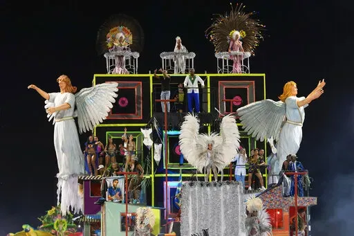 Dancers from the Unidos da Vila Maria samba school perform on a float during a carnival parade in Sao Paulo, Brazil, Saturday, April 23, 2022. (AP Photo/Andre Penner)
