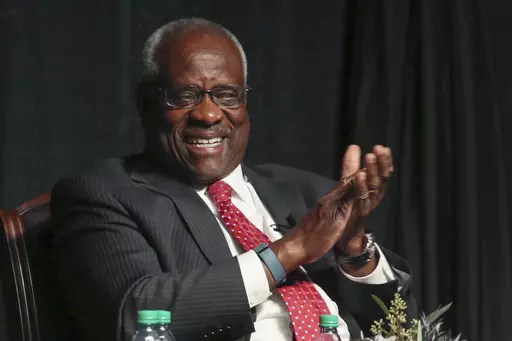 Supreme Court Justice Clarence Thomas laughs before speaking to an audience at McLennan Community College in Waco, Texas, on Sept. 7, 2017. Records obtained by The Associated Press show that Supreme Court justices have attended publicly funded events at colleges and universities that allowed the schools to put the justices in the room with influential donors, including some whose industries have had interests before the court. (Rod Aydelotte/Waco Tribune-Herald via AP, File)