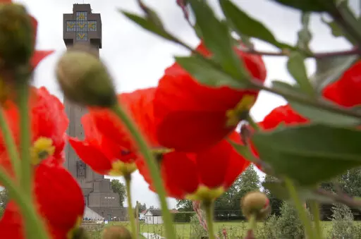 Red poppies bloom in front of the World War I Ijzertoren (Yser Tower) Monument in Diksmuide, Belgium, June 17, 2014. In Belgium, where bodies of World War I are still being found in Flanders Fields to this day, the Yser Tower contains an inscription of "No more war", in four languages so no one misses the point. (AP Photo/Virginia Mayo, File)