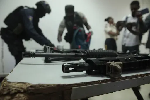 Police display weapons and equipment seized from gangs during a press conference at police headquarters in Port-au-Prince, Haiti, April 26, 2023. (AP Photo/Odelyn Joseph, File)