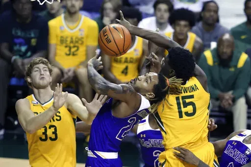 McNeese State forward Christian Shumate (24) battles Baylor forward Josh Ojianwuna (15) and Caleb Lohner (33) for control of the ball in the second half of an NCAA college basketball game, Wednesday, Nov. 23, 2022, in Waco, Texas. (AP Photo/Rod Aydelotte)