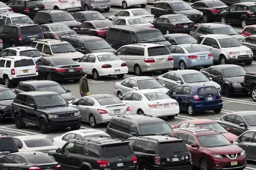A person walks through a parking lot at a shopping mall on Dec. 8, 2016 in King of Prussia, Pa. Many newer cars use wireless key fobs and push-button starters. The technology makes it more convenient to get into your vehicle, but it also makes things easier for thieves. (AP Photo/Matt Rourke, File)