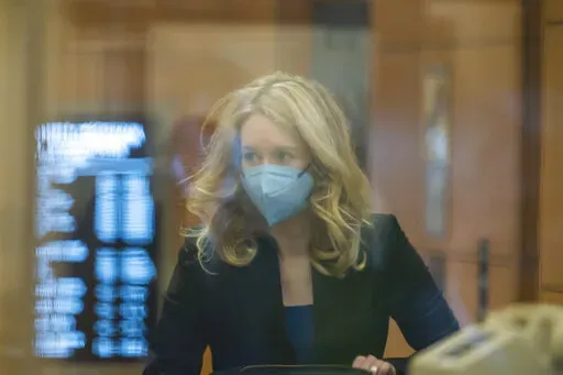 Elizabeth Holmes walks into federal court in San Jose, Calif., Monday, Nov. 22, 2021. Holmes is accused of duping elite financial backers, customers and patients into believing that her startup was about to revolutionize medicine. (AP Photo/Nic Coury)