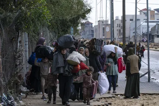 Palestinians arrive in the southern Gaza town of Rafah after fleeing an Israeli ground and air offensive in the nearby city of Khan Younis on Monday, Jan. 29, 2024. Israel has expanded its offensive in Khan Younis, saying the city is a stronghold of the Hamas militant group. (AP Photo/Fatima Shbair)