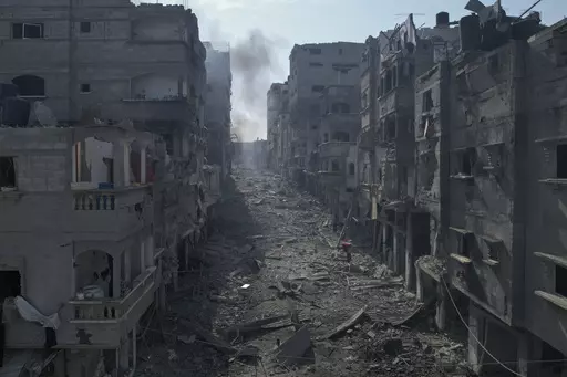 Rubble litters a street between smoldering buildings hit by an Israeli airstrike in Jabaliya, Gaza Strip, Wednesday, Oct. 11, 2023. (AP Photo/Hatem Moussa)