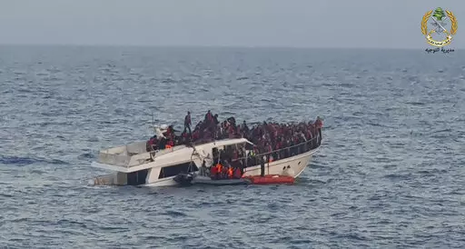 File In this photo released by the Lebanese Army, shows Lebanese army on their dinghy, rescuing migrants from a boat sinking in the Mediterranean Sea, near the shores of Tripoli, north Lebanon, Saturday, Dec. 31, 2022. A short Lebanese army statement said the vessel was carrying people "who were trying to illegally leave Lebanon's territorial waters." It said three Lebanese navy boats and one from the U.N. peacekeeping force in Lebanon, known as UNIFIL, were rescuing the approximately 200 migran