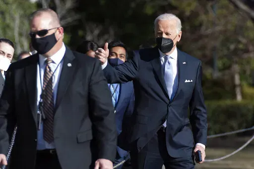 President Joe Biden gives a thumbs up as he walks to board Marine One on the South Lawn of the White House, Friday, Feb. 11, 2022, in Washington to travel to Camp David, Md. (AP Photo/Manuel Balce Ceneta)