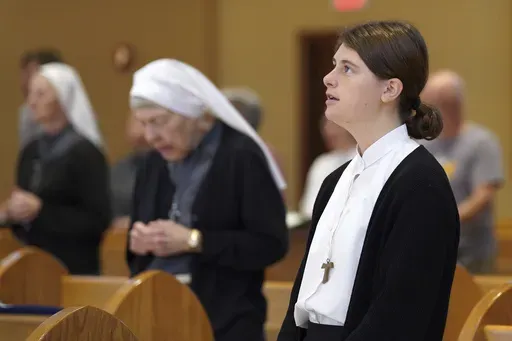 Zoey Stapleton, a postulant with the Franciscan Sisters, T.O.R. of Penance of the Sorrowful Mother, attends Mass in Toronto, Ohio, Thursday, Nov. 7, 2024. (AP Photo/Jessie Wardarski)