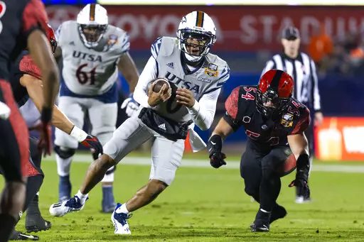 UTSA quarterback Frank Harris (0) carries during the second half of the team's Frisco Bowl NCAA college football game against San Diego State, Tuesday, Dec. 21, 2021, in Frisco, Texas. Six Conference USA teams will have one last chance to hoist a championship trophy before moving to the American Athletic Conference in 2023. (AP Photo/Sam Hodde, File)