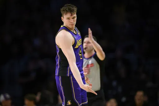 Los Angeles Lakers guard Dalton Knecht reacts after making a 3-point basket during the first half of an NBA basketball game against the New Orleans Pelicans, Friday, April 4, 2025, in Los Angeles. (AP Photo/William Liang)