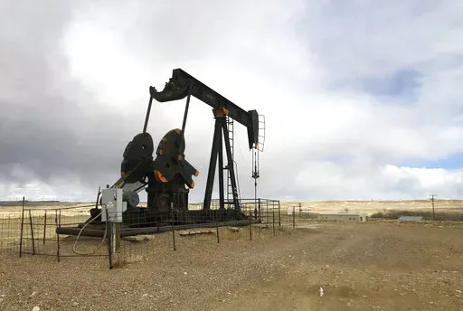 This Feb. 26, 2021, file photo shows an oil well east of Casper, Wyo. The Biden administration is raising royalty rates that companies must pay for oil and natural gas extracted from federal lands as it moves forward under court order with sales of public fossil fuel reserves in nine states. (AP Photo/Mead Gruver, File)