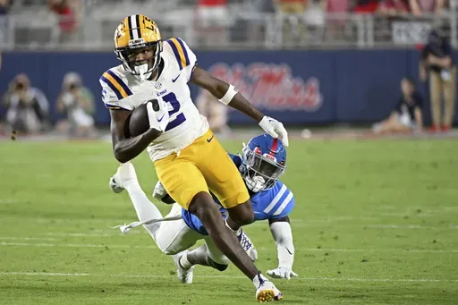 LSU wide receiver Kyren Lacy (2) avoids Mississippi safety Ladarius Tennison (13) during the second half of an NCAA college football game in Oxford, Miss., Sept. 30, 2023. (AP Photo/Thomas Graning, File)