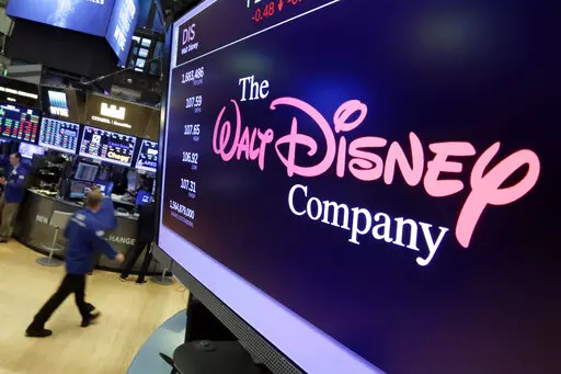 In this Aug. 8, 2017, file photo, The Walt Disney Co. logo appears on a screen above the floor of the New York Stock Exchange. Disney is working on sequels for its “Toy Story,” “Frozen” and “Zootopia” franchises as the company concentrates more on brands that have continued to perform well. The Walt Disney Co. is working on a “strategic transformation,” announced by CEO Bob Iger on Wednesday, Feb. 8 2023. (AP Photo/Richard Drew, File)