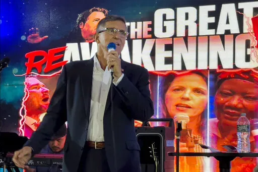 Michael Flynn, a retired three-star general who served as Trump's national security adviser, speaks on stage during the ReAwaken America tour at Cornerstone Church, in Batavia, N.Y., Friday, Aug. 12, 2022. Thousands of people gathered to hear his message that the nation is facing an existential threat, and to save it, his supporters must act. (AP Photo/Carolyn Kaster)