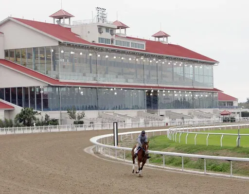 A hore goes through an early morning workout for the first time since Hurricane Katrina at the Fair Ground Race Track in New Orleans, La., on Nov. 2, 2006. A federal appeals court has ruled Friday, Nov. 18, 2022, that Congress gave too much power to a nonprofit authority it created in 2020 to develop and enforce horseracing rules. The 5th U.S. Circuit Court of Appeals said that the Horseracing Integrity and Safety Act is “facially unconstitutional.”(AP Photo/Bill Haber, File)