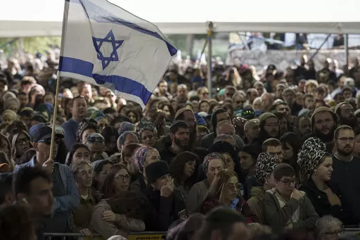 Mourners attend the funeral of Israeli staff sergeant Elisha Yehonatan Lober, who was killed in battle in the Gaza Strip, at the Mount Herzl military cemetery in Jerusalem, Israel, Wednesday, Dec. 27, 2023. (AP Photo/Leo Correa)