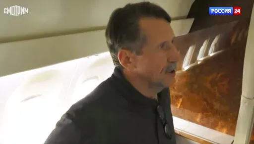 In this image taken from video provided by RU-24 Russian Television on Friday, Dec. 9, 2022, Russian citizen Viktor Bout who was exchanged for U.S. basketball player Brittney Griner, speaks in a Russian plane after a swap, in the airport of Abu Dhabi, United Arab Emirates. Russian arms dealer Bout, who was released from U.S. prison in exchange for WNBA star Griner, is widely labeled abroad as the "Merchant of Death" who fueled some of the world's worst conflicts but seen at home as a swashbuckli