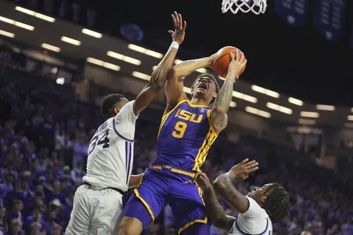 LSU forward Jalen Reed (9) shoots under pressure from Kansas State center Ugonna Onyenso (34) during the first half of an NCAA college basketball game Thursday, Nov. 14, 2024, in Manhattan, Kan. (AP Photo/Charlie Riedel)