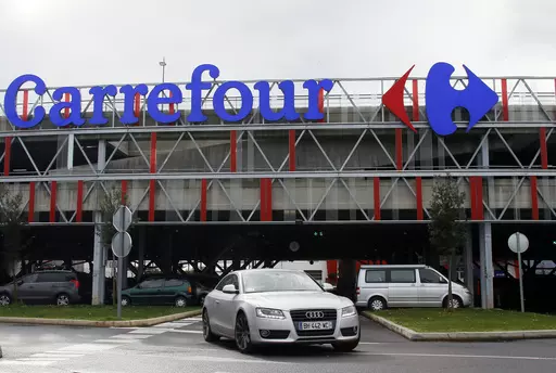 Car leaves a Carrefour supermarket in Anglet, southwestern France, on Jan.23, 2018. Global supermarket chain Carrefour will stop selling PepsiCo products in its stores in France, Belgium, Spain and Italy over price increases for popular items like Lay's potato chips, Quaker Oats, Lipton tea and its namesake soda. (AP Photo/Bob Edme, File)