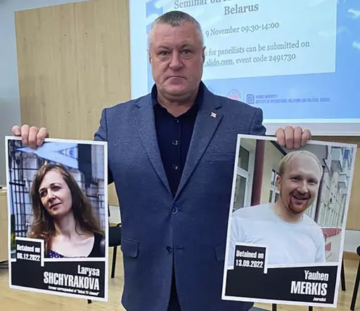In this handout photo from the Viasna Human Rights Center, Leanid Sudalenka, an activist from Belarus, holds portraits of imprisoned journalists Larysa Shchyrakova and Yauhen Merkis, in Belostok, Poland, Sunday, Nov. 5, 2023. Sudalenka, who was imprisoned for three years in Belarus, said authorities there hold political prisoners in conditions amounting to "torture." He told The Associated Press that when he was in a Belarusian penal colony, he nearly died from COVID-19 and a lack of medical car