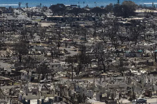Charred remains of homes are visible following a wildfire in Lahaina, Hawaii, Aug. 22, 2023. The number of people still missing following wildfires that destroyed the historic community of Lahaina a month ago has dropped, Hawaii Gov. Josh Green said Friday, Sept. 8, 2023, while the number of confirmed deaths has remained at 115. (AP Photo/Jae C. Hong, File)