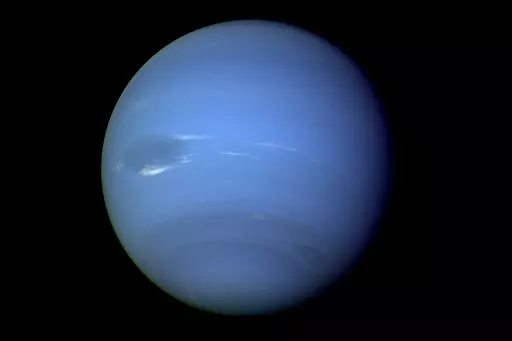 This August 1989 image provided by NASA shows the planet Neptune photographed by the Voyager 2 spacecraft, processed to enhance the visibility of small features. The International Astronomical Union's Minor Planet Center announced Friday , Feb. 23, 2024, that astronomers have found three previously unknown moons in our solar system — two additional moons circling Neptune and one around Uranus. (NASA via AP)