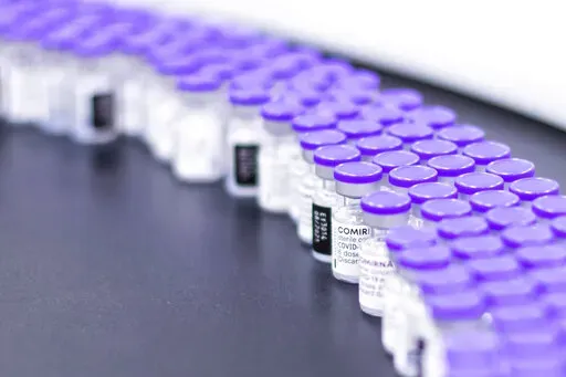 In this March 2021 photo provided by Pfizer, vials of the Pfizer-BioNTech COVID-19 vaccine are prepared for packaging at the company's facility in Puurs, Belgium. According to a study published Thursday. June 23, 2022 in the journal Lancet Infectious Diseases, nearly 20 million lives were saved by COVID-19 vaccines during their first year, but even more deaths could have been prevented if global targets had been reached. (Pfizer via AP)