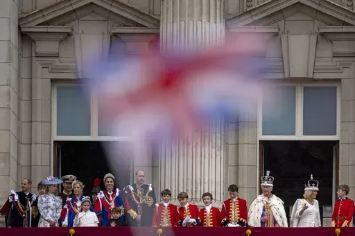 Britain's King Charles III and Queen Camilla wave to the crowds from the balcony of Buckingham Palace after the coronation ceremony in London, Saturday, May 6, 2023. King Charles III’s decision to be open about his cancer diagnosis has helped the new monarch connect with the people of Britain and strengthened the monarchy in the year since his dazzling coronation at Westminster Abbey. (AP Photo/ Andreea Alexandru, File)
