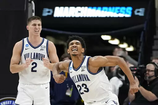 Villanova forward Jermaine Samuels celebrates after scoring with guard Collin Gillespie during the second half of a college basketball game against Michigan in the Sweet 16 round of the NCAA tournament on Thursday, March 24, 2022, in San Antonio. (AP Photo/David J. Phillip)