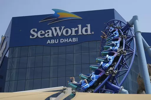 People enjoy riding on a roller coaster at the SeaWorld on Yas Island in Abu Dhabi, United Arab Emirates, on May 26, 2023. It’s the first venture outside the United States for the theme park chain, which had been mired in controversy in recent years over the treatment of captive killer whales. The $1.2 billion Abu Dhabi venture with state-owned developer Miral features the world's largest aquarium and cylindrical LED screen, as well as state-of-the-art facilities housing dolphins, seals, and o