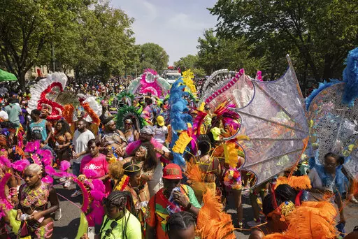 Participants in costume walk during the West Indian Day Parade, Monday, Sept. 5, 2022, in the Brooklyn borough of New York. (AP Photo/Yuki Iwamura)