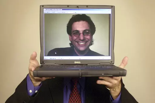 Computer hacker turned author Kevin Mitnick poses for a portrait Thursday, June 27, 2002, in Las Vegas. Mitnick, whose pioneering antics tricking employees in the 1980s and 1990s into helping him steal software and services from big phone and tech companies made him the most celebrated U.S. hacker, has died at age 59. (AP Photo/Joe Cavaretta, File)