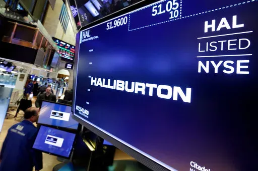 The logo for Halliburton appears above a trading post on the floor of the New York Stock Exchange, Monday, April 23, 2018.  U.S. oil field services companies Halliburton Co. and Schlumberger are suspending their operations in Russia as the Houston, Texas-based businesses react to U.S. sanctions over Russia’s invasion of Ukraine.   (AP Photo/Richard Drew, File)