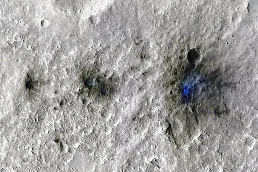 This undated photo released by NASA shows craters that were formed by a Sept. 5, 2021, meteoroid impact on Mars, the first to be detected by NASA’s InSight. Taken by NASA’s Mars Reconnaissance Orbiter, this enhanced-color image highlights the dust and soil disturbed by the impact in blue in order to make details more visible to the human eye. NASA lander on Mars has captured the vibrations and sounds of four meteorites striking the planet's surface. Scientists reported Monday, Sept. 19, 2022