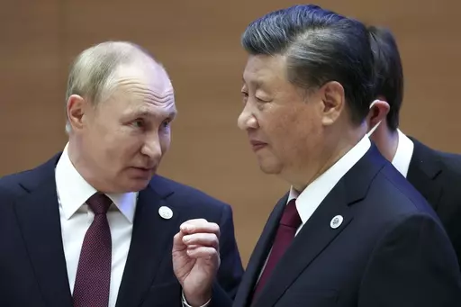 Russian President Vladimir Putin, left, gestures while speaking to Chinese President Xi Jinping during the Shanghai Cooperation Organization (SCO) summit in Samarkand, Uzbekistan, Sept. 16, 2022. China said Friday, March 17, 2023, President Xi will visit Russia from Monday, March 20, to Wednesday, March 22, 2023, in an apparent show of support for Russian President Putin amid sharpening east-west tensions over the conflict in Ukraine. (Sergei Bobylev, Sputnik, Kremlin Pool Photo via AP, File)