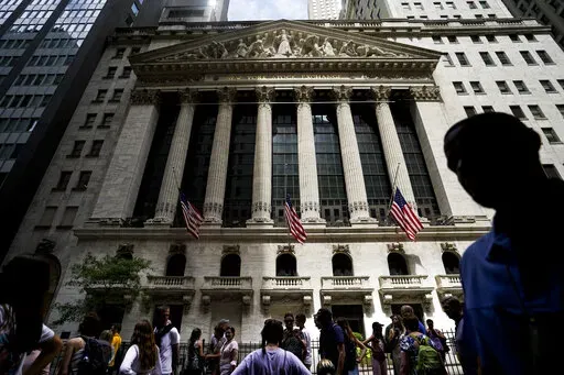 Pedestrians walk past the New York Stock Exchange on  Friday, July 8, 2022, in New York. Stocks are falling on Wall Street on Wednesday, July 13, 2022, after a highly anticipated report on inflation turned out to be even worse than expected. (AP Photo/John Minchillo, File)